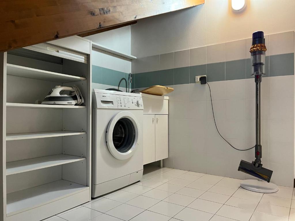 Dedicated laundry area with washing machine, sink, iron and storage